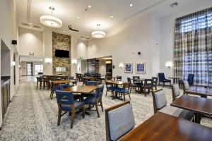 a restaurant with tables and chairs and a large window at Homewood Suites By Hilton Phoenix Tempe Asu Area in Tempe