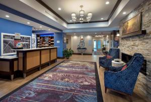 a lobby with a bar and a fireplace at Hampton Inn by Hilton New Paltz, NY in New Paltz