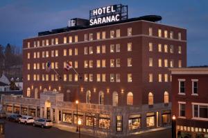 a building with a sign on the top of it at Hotel Saranac, Curio Collection By Hilton in Saranac Lake