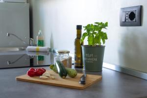 a cutting board with a plant and a bottle of wine at Ca Emma - Homy Home in Turin
