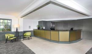 a lobby with a reception desk and chairs at DoubleTree by Hilton Southampton in Southampton