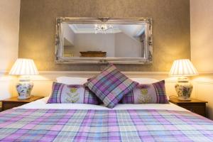 A bed or beds in a room at Muckrach Country House Hotel 