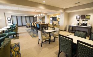 a restaurant with tables and chairs and a cafeteria at Hampton Inn Decatur, Mt. Zion, IL in Decatur