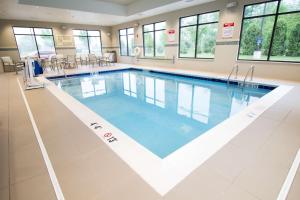 a large swimming pool with blue water in a building at Hampton Inn Decatur, Mt. Zion, IL in Decatur