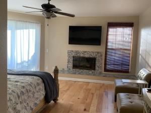 a bedroom with a bed and a fireplace at Pacific Breeze Right Next to Huntington Beach Pier! Steps from Beach!! in Huntington Beach