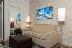 a living room with a couch and a bedroom at Home2 Suites By Hilton Nokomis in Nokomis