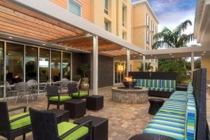 an outdoor patio with chairs and a fire pit at Home2 Suites By Hilton Nokomis in Nokomis