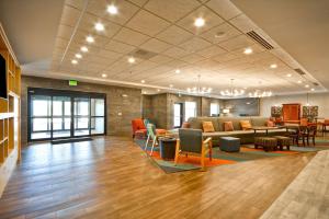 a lobby with a couch and tables and chairs at Home2 Suites By Hilton Evansville in Evansville