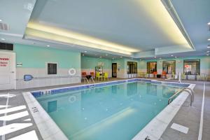 a large swimming pool in a hotel room at Home2 Suites By Hilton Evansville in Evansville