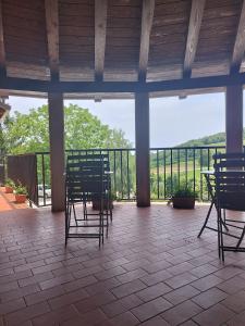 a porch with chairs and a view of a mountain at Agriturismo Ca 'd Tistu in San Benedetto Belbo