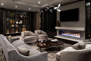 a living room with couches and a fireplace at Hampton Inn & Suites Bridgewater, NJ in Bridgewater