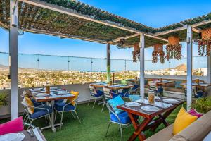 a restaurant with tables and chairs on a roof at Morgan Residences 508 in Cabo San Lucas