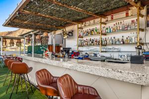 a bar with brown chairs and a counter at Morgan Residences 508 in Cabo San Lucas