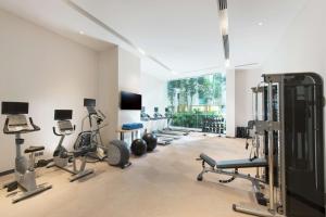 a gym with a bunch of exercise equipment in a room at Hilton Garden Inn Singapore Serangoon in Singapore