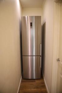 a stainless steel refrigerator in the corner of a room at CHATHAM GUEST HOUSE in Chatham
