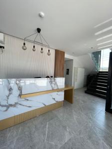 a large room with a bed and a staircase at Absolute Hotel Ksamil in Ksamil