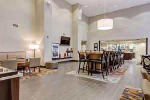 a lobby with a table and chairs and a bar at Hampton Inn-St. Louis Wentzville, MO in Wentzville