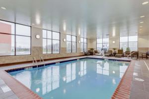 a large swimming pool in a building with windows at Hampton Inn-St. Louis Wentzville, MO in Wentzville