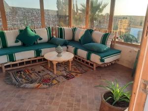 a living room with a couch and a table at Villa Caroubier in Essaouira
