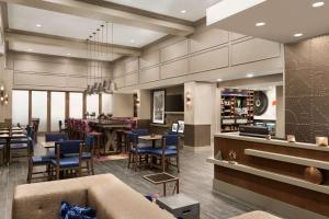 a lobby with a bar and a restaurant at Hampton Inn & Suites Seattle/Renton, Wa in Renton