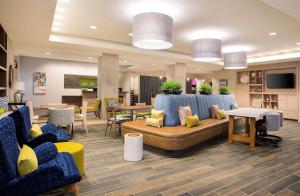 牛津Home2 Suites By Hilton Oxford的配有沙发和桌椅的大厅