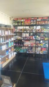 a store aisle with shelves of food in a store at Aiezza Hotel in Barcarena