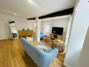 a living room with a blue couch and a television at Precioso apartamento reformado 2HAB in Elanchove