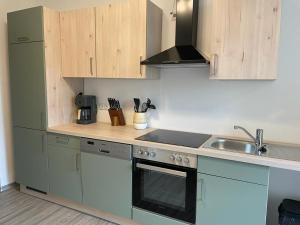 a kitchen with a sink and a stove top oven at Ferienwohnung "An der Querne" Querfurt in Querfurt