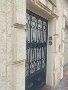 a black door with a wrought iron gate on a building at Al Khaldiyyah Nights Studio in Riyadh