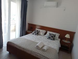 a bedroom with a bed with two towels on it at Dubrovnik Apartment Nepe in Dubrovnik
