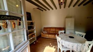 a living room with a table and a couch at Gite Normandie in Forges-les-Eaux +18 photos