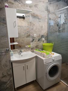 a bathroom with a washing machine and a sink at Dubrovnik Apartment Nepe in Dubrovnik
