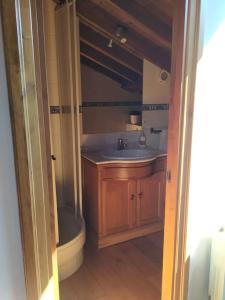 a bathroom with a sink and a toilet at Casa barrio el Reloj - Lastres in Lastres +28 photos