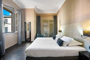 Rúm í herbergi á Hotel POZZO DI BORGO