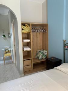 a bedroom with a bed and a closet with shoes at Katerinas Inn Apartments in Keri