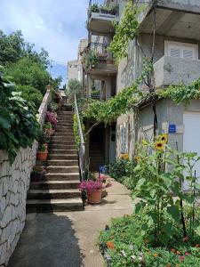 a stairway leading up to a building with flowers at Dubrovnik Apartment Nepe in Dubrovnik