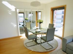 a dining room with a glass table and chairs at Finest Rentals - Expo Riverside in Lisbon