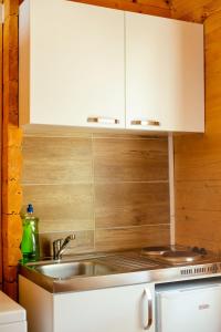 a kitchen with a sink and a white cabinet at KATANA VILLAGE APARTMENT in Ulcinj