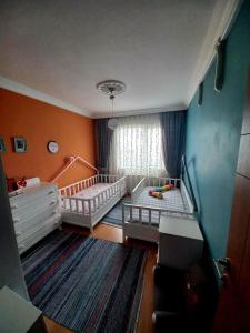 a baby room with two beds and a crib at Nehir apart in Rize