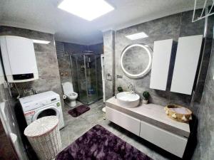 a bathroom with a sink and a washing machine at Nehir apart in Rize