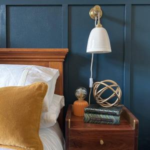 a lamp on a night stand next to a bed at Glenesk No 1 , Woodhall Spa in Lincolnshire