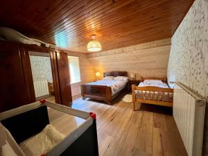 - une chambre avec 2 lits dans une cabane en bois dans l'établissement Maison reposante, à Saint-Alyre-ès-Montagne