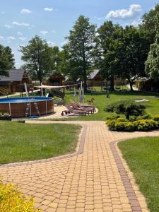 a park with a playground with a slide at Domki i pokoje "ZIELONA PRZYSTAŃ" in Sztutowo