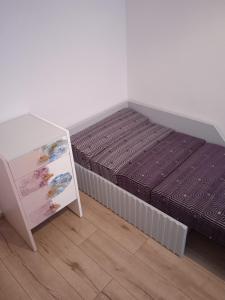 a bedroom with a bed and a book shelf at M2 Art in Giżycko