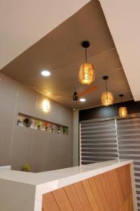una cocina con dos luces colgantes y una encimera en V.A TOURIST RESIDENCY en Taliparamba