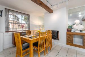 a kitchen and dining room with a wooden table and chairs at Bard's Cottage in Alcester