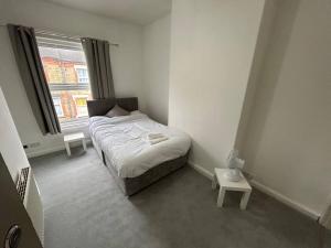 a small bedroom with a bed and a window at Perfect Home From Home In Stoke on Trent in Etruria