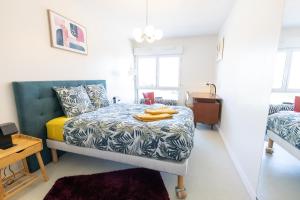een slaapkamer met een bed met een gele deken bij Le Royal 4* – Grand Confort Salle de Sport privée in Vandoeuvre-lès-Nancy