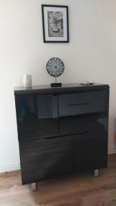 a black dresser with a lamp on top of it at Appartement Fx 1 in Saint Die