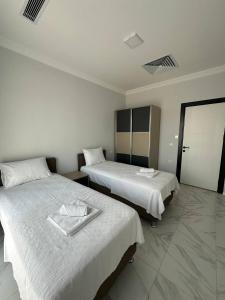 a hotel room with two beds with towels on them at Talia Villalari in Fethiye